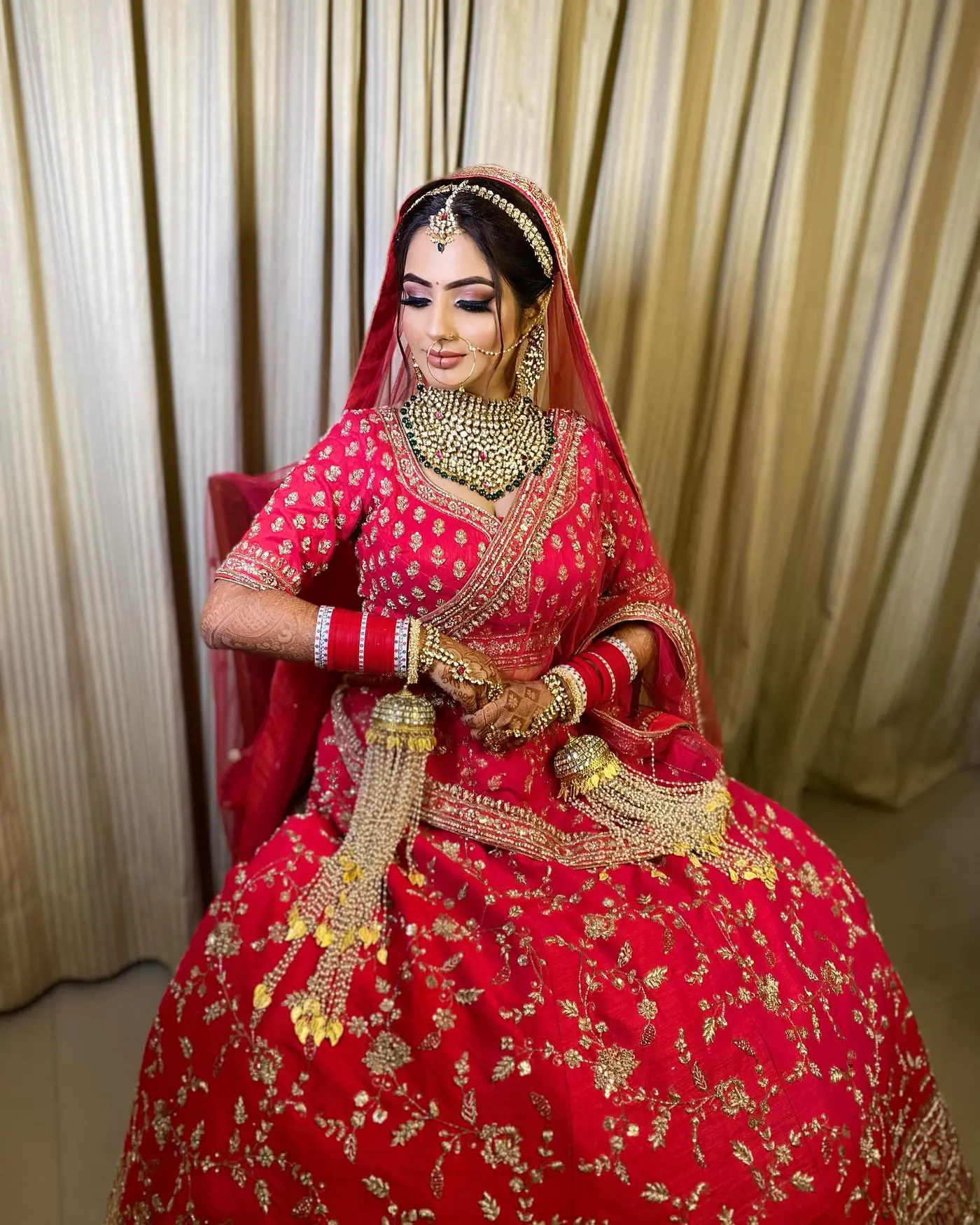 Gold Dupatta, Jhoomer, Seated. Bridal makeup by Madhu Gupta at MG Makeovers, Gurugram